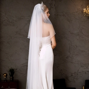 Close-up of white double-layered bridal veil with beaded edges and silver crown