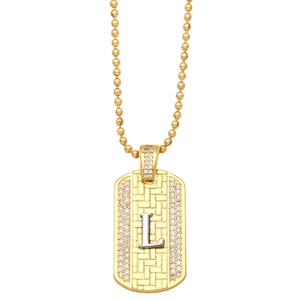 Detail of gold dog tag pendant with silver letter L and sparkling rhinestone border