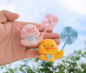 Close-up of cute pink pig and yellow duck cartoon car air vent freshener ornaments