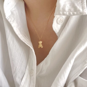 Minimalist 925 sterling silver bear pendant necklace with heart detail worn on neck