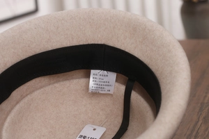 Detail of wool felt hat interior showing the 100% sheep wool label and black sweatband