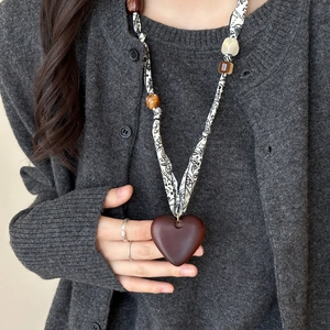 Deep red heart pendant necklace with black and white geometric pattern fabric strap
