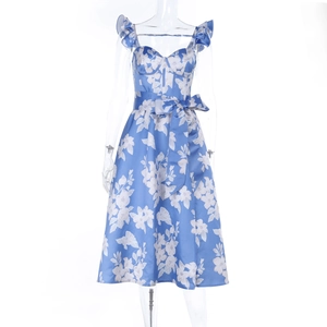 Detail of blue floral satin dress featuring a functional bow tie waistband and smooth texture