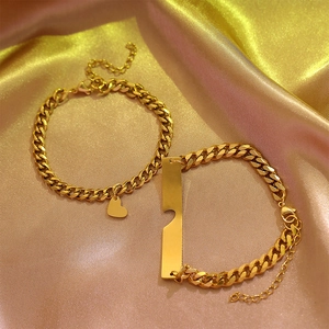 Luxury gold-plated stainless steel heart and bar couple bracelets on satin fabric