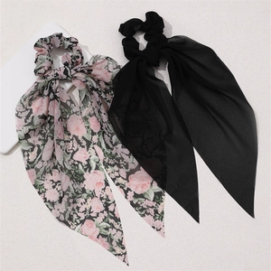 Detail of black and pink floral chiffon hair scrunchies with long ribbon ties