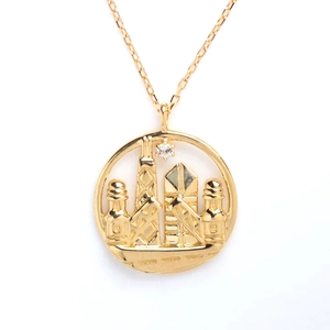 Close-up of golden S925 sterling silver necklace with city landmark pendant and zircon