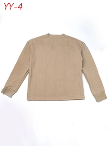 Close-up detail of beige knitted sweater with vertical diamond and cable stitch texture