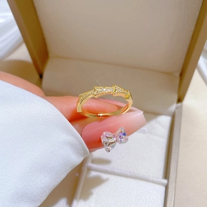 Adjustable gold bamboo ring with arrow motifs and micro-set cubic zirconia crystals