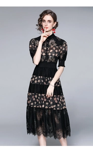 Detailed close-up of black lace midi dress with floral pattern and button front detail
