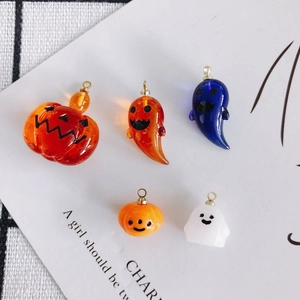 Macro view of Halloween pumpkin and ghost resin pendants with clear acrylic texture