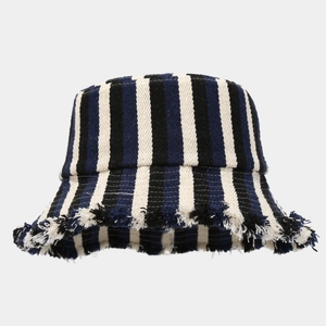 Striped navy and cream fisherman hat with fringed edges in a minimalist studio shot