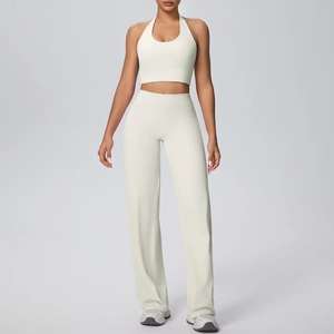 Detail view of cream halter-neck crop top and high-waist wide-leg yoga trousers set