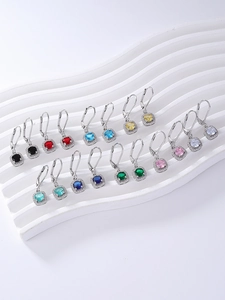 Detailed macro view of square multi-color zircon earrings in polished silver settings