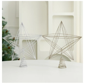 Detail of glittered iron Christmas tree toppers in gold and silver with spiral bases