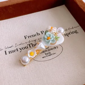Sweet heart shaped hair clip with mint green floral accents and white faux pearls