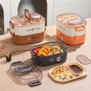Detail of double-layer stainless steel lunch box featuring a cute bear pattern and dividers