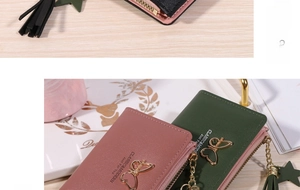 Detail of pink and dark green wallets with butterfly metal buckle and tassel zipper
