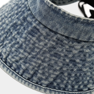 Macro shot of blue washed denim sun hat featuring waffle texture and durable stitching
