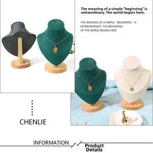 Detail showing velvet necklace display busts in dark green and grey with solid wood bases