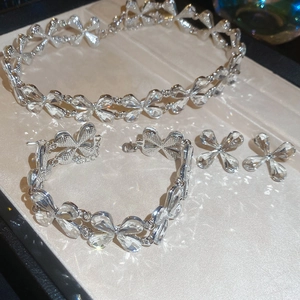 Macro shot of silver clover jewelry set with sparkling crystals in a premium box