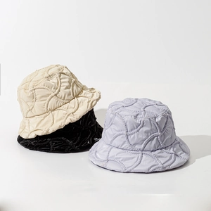 Quilted bucket hats for winter in beige, black, and purple with wavy textured stitching