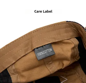 Close-up of the care label on a 100% cotton vintage newsboy cap with stitching detail