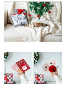 Close-up of Merry Christmas gift cards and 3D Santa packaging in a warm festive setting
