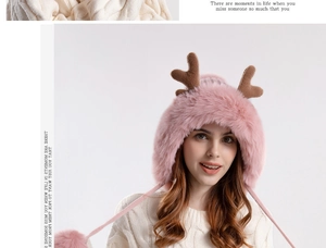 Detail of pink plush earflap hat featuring brown antlers and long faux fur pom-pom drawstrings