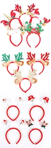Detailed view of various Christmas headbands with reindeer antlers and festive dolls