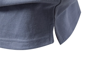 Detail of piqué fabric polo shirt with reinforced side slit and twin-needle stitching