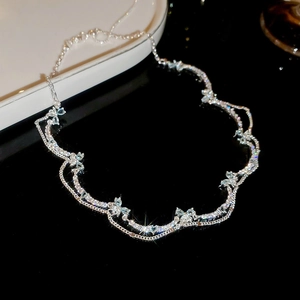 Macro detail of silver layered necklace with sparkling blue zircon butterfly pendants