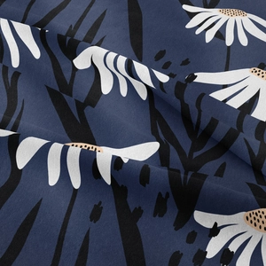 Detail of bohemian daisy tapestry fabric showing navy blue knit texture and floral patterns