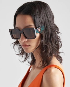 Detail of tortoiseshell square sunglasses with green marble pattern on temple logo