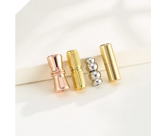 Detail view of various spiral and magnetic 18K gold and silver jewelry clasps