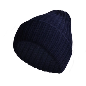 Close-up of deep navy blue ribbed knit texture on a warm winter beanie hat