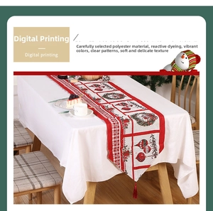 Close-up of digital printing Christmas table runner with festive wreath and bell patterns