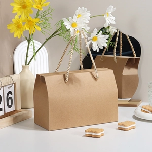 Eco-friendly brown kraft paper gift box with a unique pitched roof design and woven handle