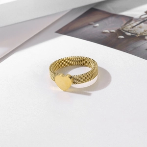 Minimalist gold woven mesh ring with a polished heart charm on white background