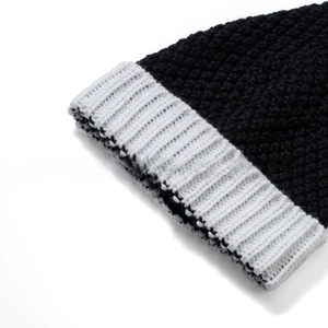 Close-up of high-quality knit texture and ribbed white cuff on a winter beanie hat