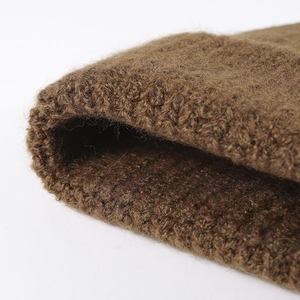 Thick dark brown wool knit beanie with chunky texture and oversized warm winter design