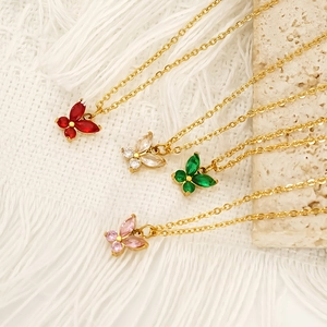Colorful butterfly pendant necklaces in four gemstone colors on a natural stone base