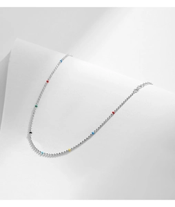 Detailed shot of a thin S925 sterling silver bracelet featuring colorful beads on a white surface