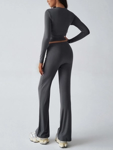 Back view of dark gray slim fit long sleeve top and flared trousers two-piece set
