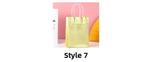 Glossy golden gift bag with white woven handles shown against a soft pastel background