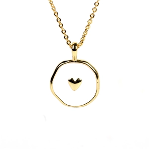 Macro detail of gold plated heart pendant necklace with white enamel inlay texture