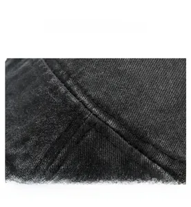 Macro detail of washed denim fabric with precise double-stitched seams on a flat top cap