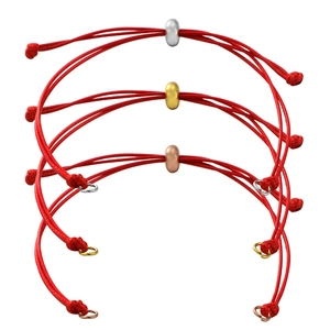 Detailed view of red braided cord bracelets with silver, gold, and rose gold metal beads