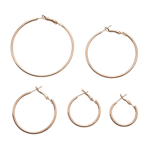 Set of five gold geometric hoop earrings in varying sizes with a polished metallic finish