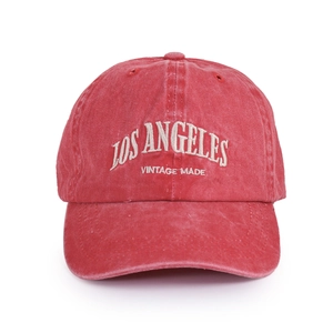 Close-up of vintage red washed baseball cap with white LOS ANGELES 3D embroidery