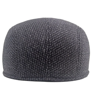 Close-up of dark grey wool blend fabric texture on men's winter flat cap